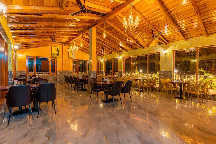 The restaurant with its timber ceiling, chandeliers and tables laid along the window side